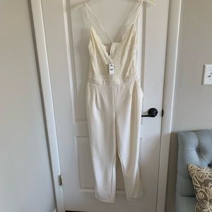Express never work white lace jumpsuit with cross cross back. Size Large.